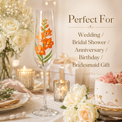 Orange gladiolus champagne flute displayed at an elegant wedding and bridal shower table