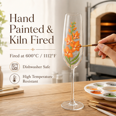 Hand painting orange gladiolus flowers on a kiln-fired champagne flute with artist brush