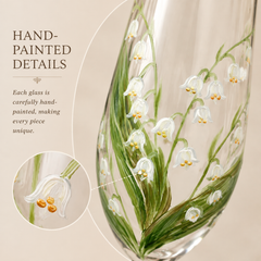 Close-up of hand-painted lily of the valley flowers and botanical details on champagne glass