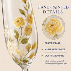 Close-up of hand-painted golden yellow roses, ivory flowers and green leaves on personalized champagne flute