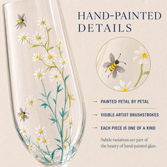 Close-up of hand-painted daisies and bees showing detailed brushstrokes on personalized champagne glass
